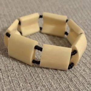 Cream colored chunky bone black beaded stretch bracelet